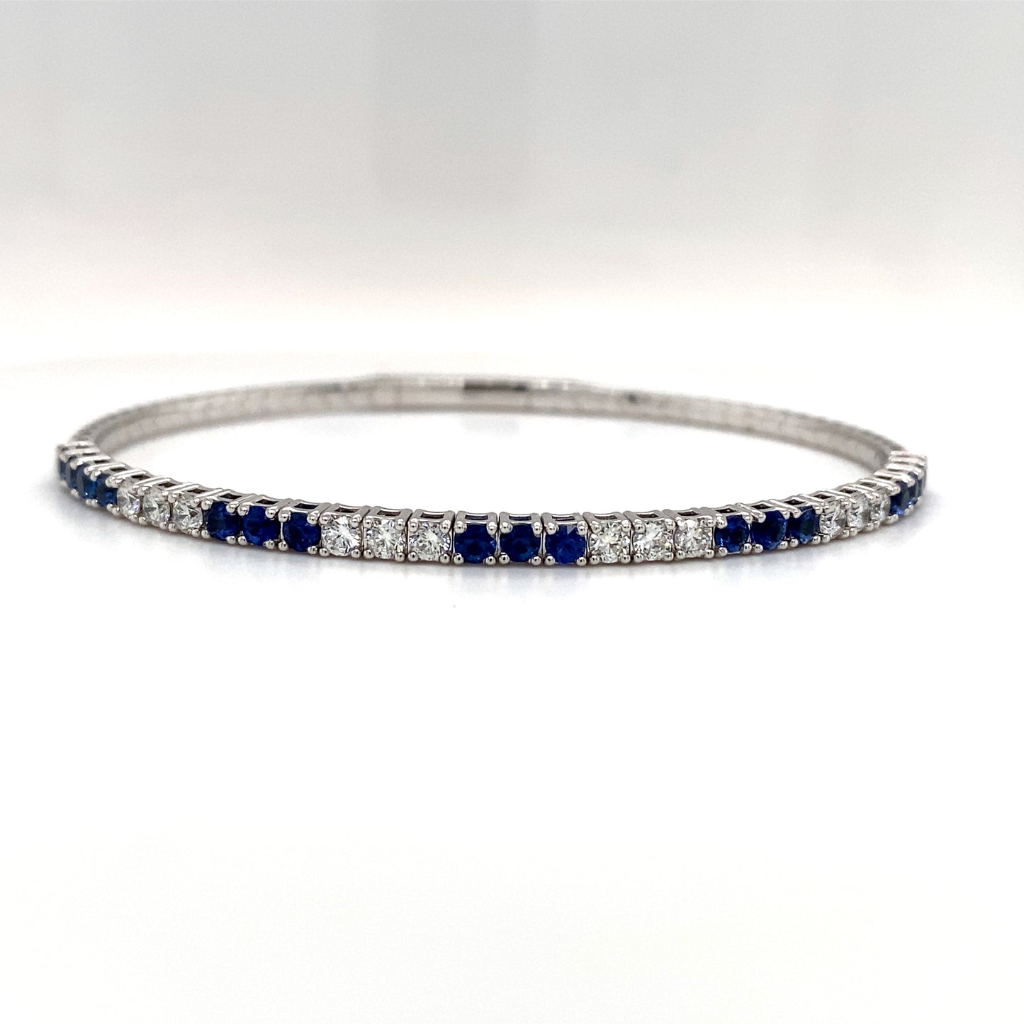 Lady's White 18 Karat Bangle Bracelet Length 2.5 With 17 1.20Tw Round Sapphires And 12 0.77Tw Round Diamonds