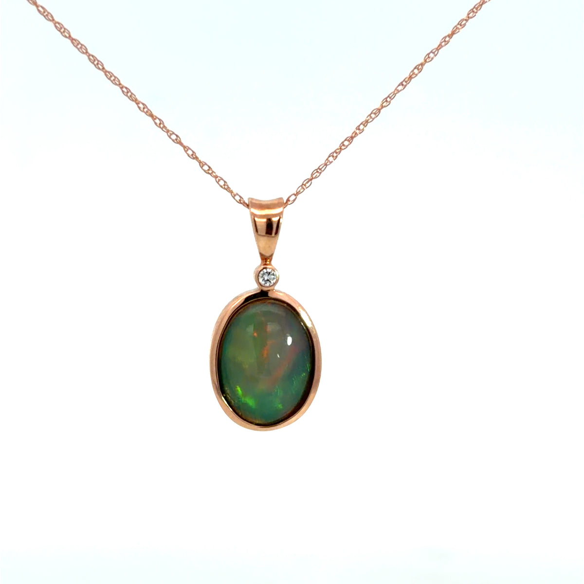 Lady's Rosé 14 Karat Bezel Pendants Length 18 With One = 1.29Ct Oval Opal And One = 0.02Ct Round H/I Si2 Diamond